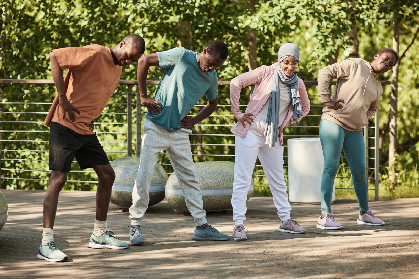 A group of adults stretching together outdoors