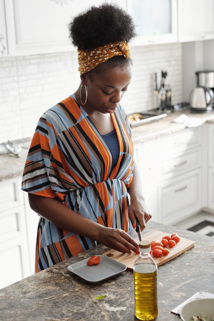 Woman preparing fresh tomatoes in her kitchen