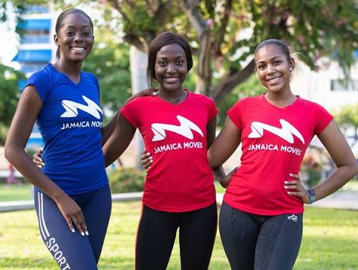 Three women wearing Jamaica Moves shirts